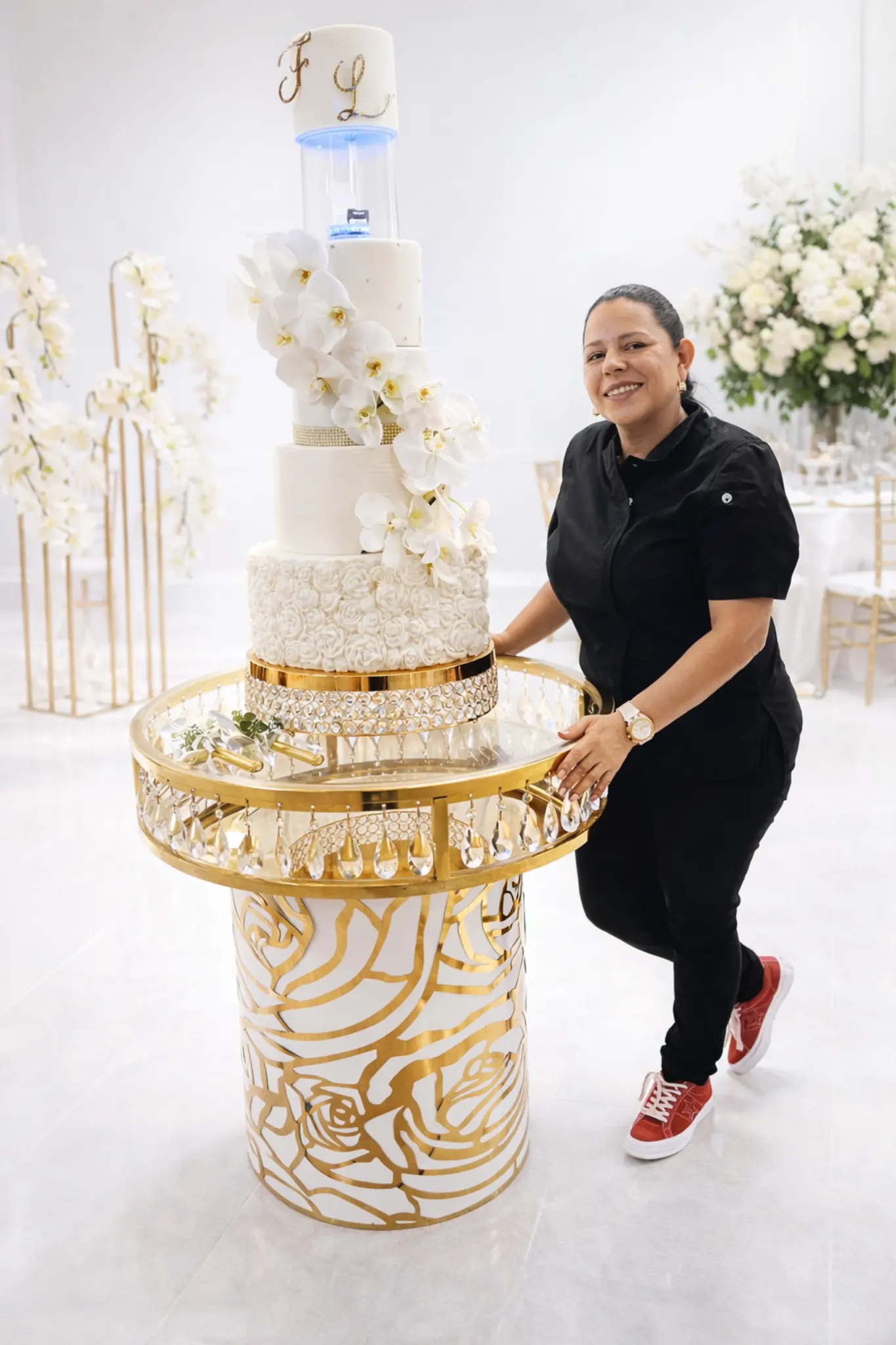 Elegant white and gold wedding cake with monogram topper Miami