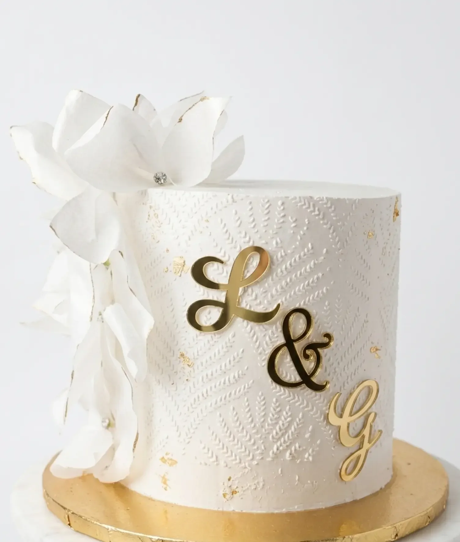 Naked wedding cake with red roses and mixed berries
