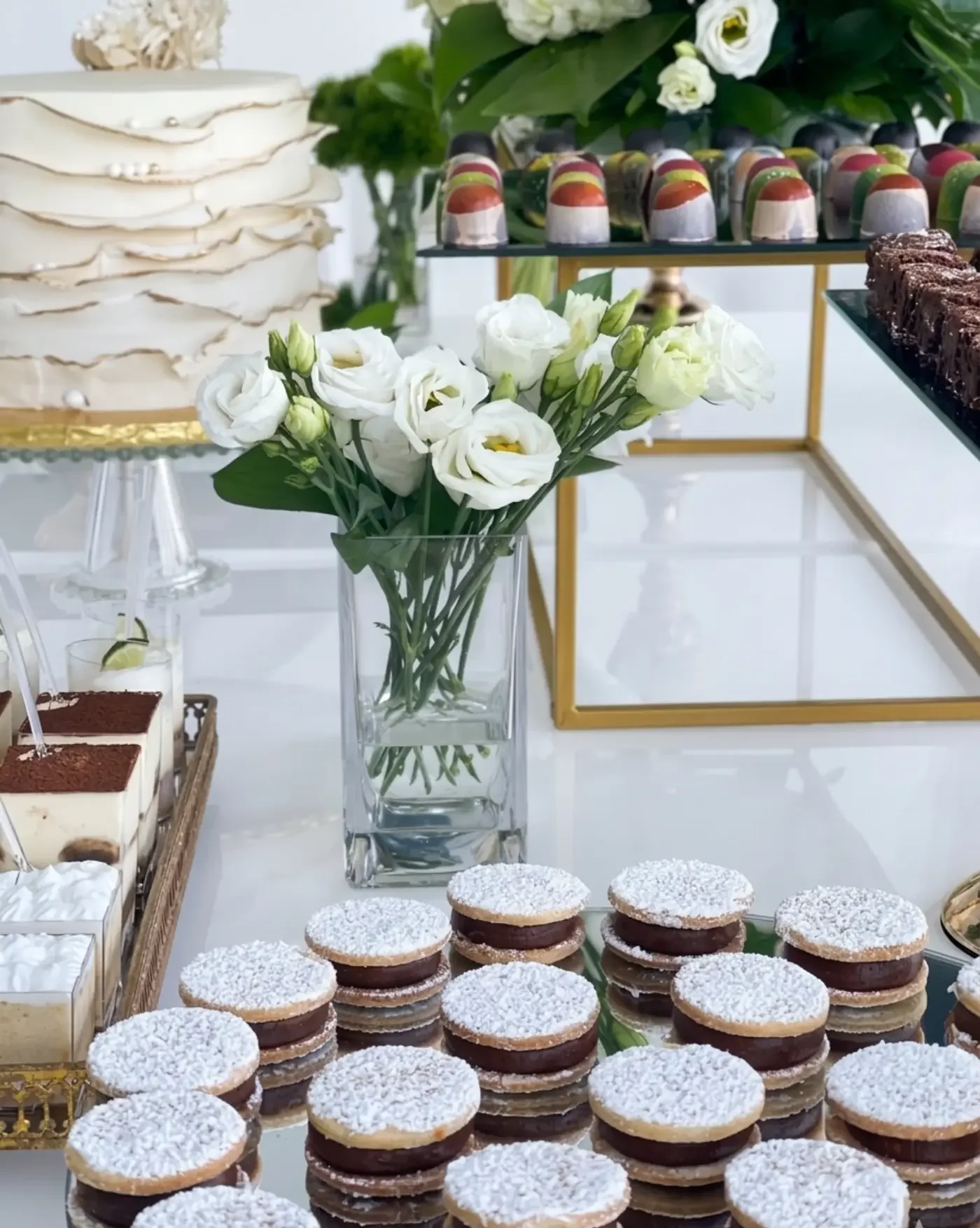 Full dessert table with alfajores brigadeiros and custom cake