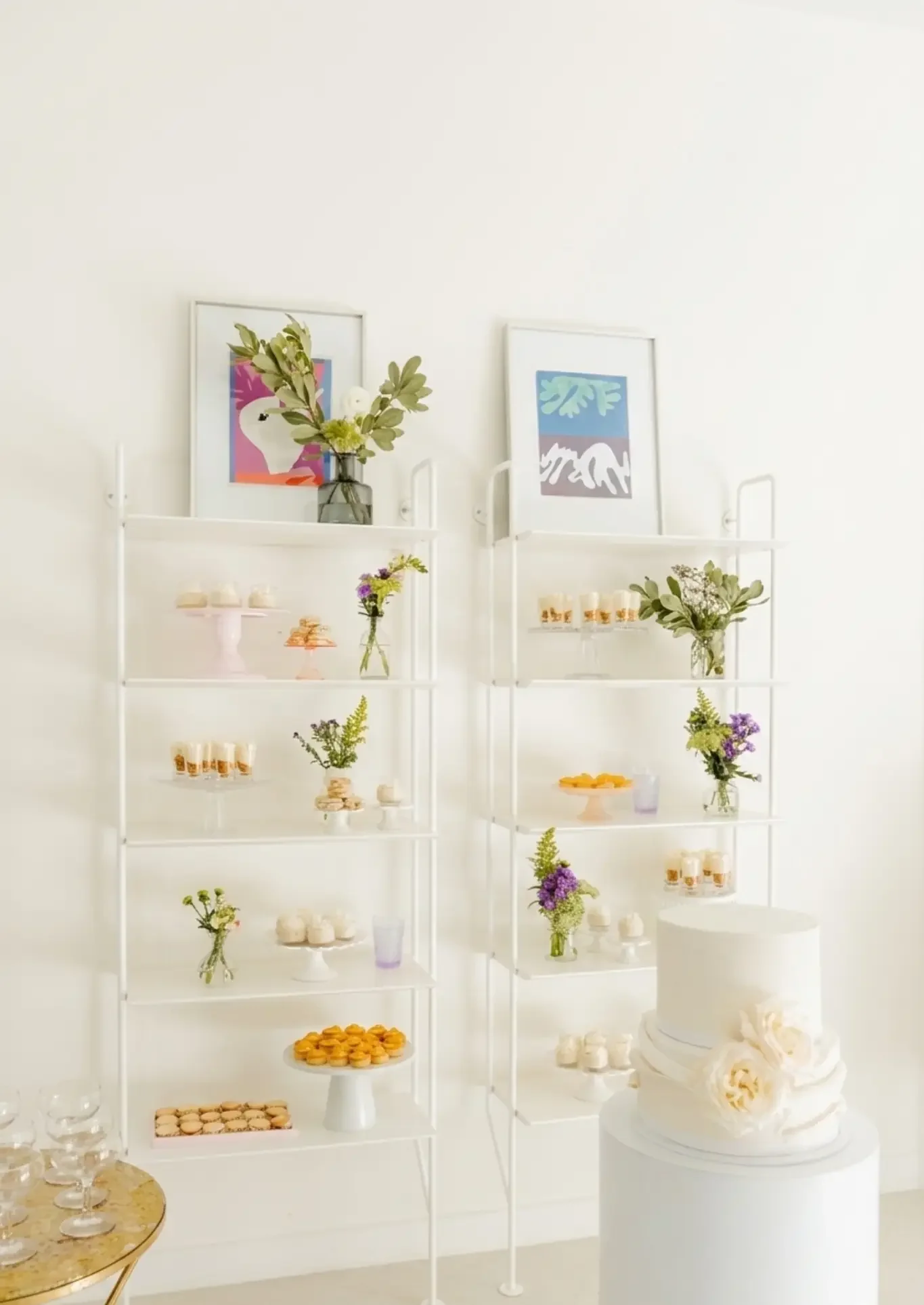 Minimalist white dessert table display with tiered shelves